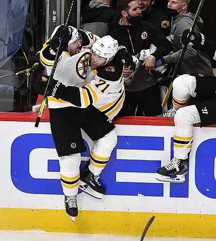 May 17, 2021; Washington, District of Columbia, USA; Boston Bruins center Brad Marchand (left) reacts after scoring the winning goal against the Washington Capitals during the first overtime period in game two of the first round of the 2021 Stanley Cup Playoffs at Capital One Arena. Mandatory Credit: Brad Mills-USA TODAY Sports