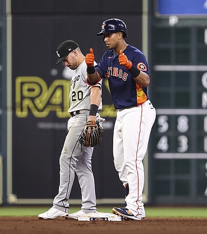 Jun 19, 2021; Houston, Texas, USA; Chicago White Sox second baseman Danny Mendick (20) looks on as Houston Astros designated hitter Michael Brantley (23) gives a thumbs up after hitting an RBI double during the fourth inning at Minute Maid Park. Mandatory Credit: Troy Taormina-USA TODAY Sports