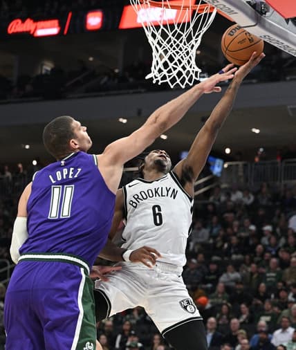 Mar 9, 2023; Milwaukee, Wisconsin, USA; Brooklyn Nets guard David Duke Jr. (6) drives to the basket against Milwaukee Bucks center Brook Lopez (11)  at Fiserv Forum. Mandatory Credit: Michael McLoone-USA TODAY Sports