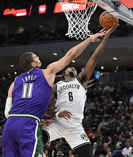Mar 9, 2023; Milwaukee, Wisconsin, USA; Brooklyn Nets guard David Duke Jr. (6) drives to the basket against Milwaukee Bucks center Brook Lopez (11)  at Fiserv Forum. Mandatory Credit: Michael McLoone-USA TODAY Sports