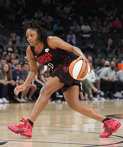 Jun 29, 2022; Phoenix, Arizona, USA; Indiana Fever guard Kelsey Mitchell (0) dribbles against the Phoenix Mercury during the second half at Footprint Center. Mandatory Credit: Joe Camporeale-USA TODAY Sports