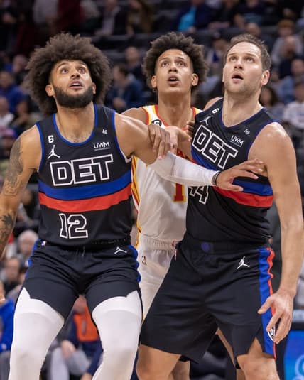 Oct 26, 2022; Detroit, Michigan, USA; Detroit Pistons forward Isaiah Livers (12) and forward Bojan Bogdanovic (44) battles for position with Atlanta Hawks forward Jalen Johnson (1) during the first half at Little Caesars Arena. Mandatory Credit: David Reginek-USA TODAY Sports