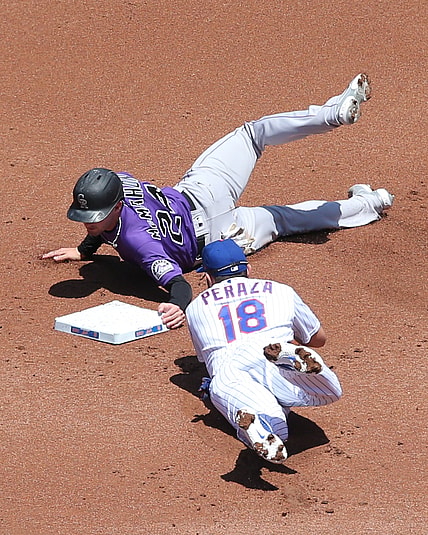 May 27, 2021; New York City, New York, USA; Colorado Rockies third baseman Ryan McMahon (24) steals second ahead of a tag by New York Mets second baseman Jose Peraza (18) during the first inning at Citi Field. Mandatory Credit: Brad Penner-USA TODAY Sports