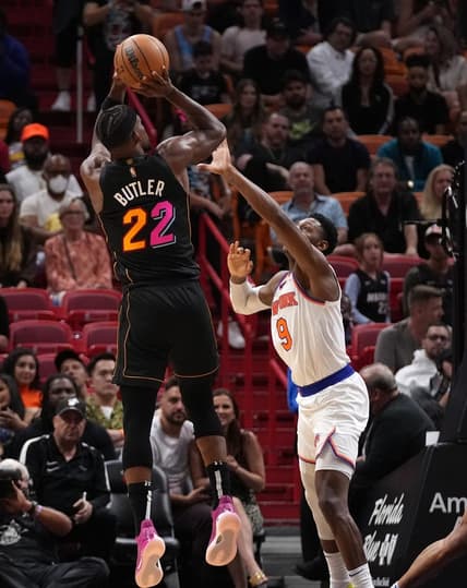 Mar 25, 2022; Miami, Florida, USA; Miami Heat forward Jimmy Butler (22) shoots the ball over New York Knicks guard RJ Barrett (9) during the second half at FTX Arena. Mandatory Credit: Jasen Vinlove-USA TODAY Sports