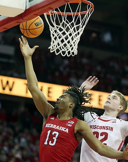 Mar 6, 2022; Madison, Wisconsin, USA; Nebraska Cornhuskers forward Derrick Walker (13) shoots over Wisconsin Badgers forward Steven Crowl (22) during the first half at the Kohl Center. Mandatory Credit: Mary Langenfeld-USA TODAY Sports