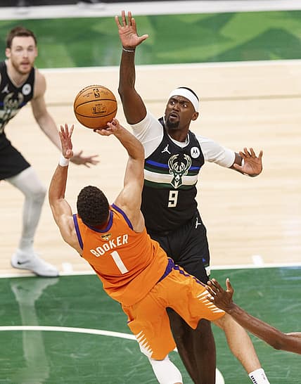 Jul 20, 2021; Milwaukee, Wisconsin, USA; Phoenix Suns guard Devin Booker (1) shoots against Milwaukee Bucks forward Bobby Portis (9) during the third quarter during game six of the 2021 NBA Finals at Fiserv Forum. Mandatory Credit: Jeff Hanisch-USA TODAY Sports
