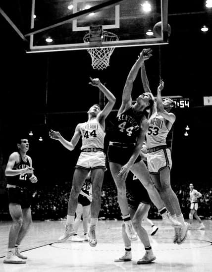 Kentucky point leader Cotton Nash (44), middle, bats a ball off the board in the second half between Bob Scott (44) and Bob Grace (53) of Vanderbilt Jan. 7, 1963. The Wildcats defeated the Commodores 106-82 before 7,324 fans at Memorial Gym Jan. 7, 1963.