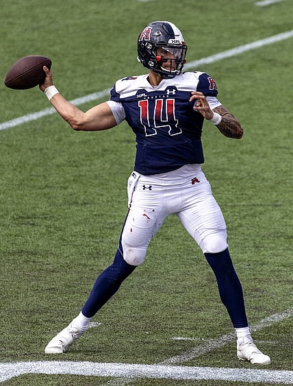 Apr 2, 2023; Houston, TX, USA;  Houston Roughnecks quarterback Cole McDonald (14) drops back to pass against the  St. Louis Battlehawks  linebacker Carson Wells (53) in the fourth quarter at TDECU Stadium. Mandatory Credit: Thomas Shea-USA TODAY Sports