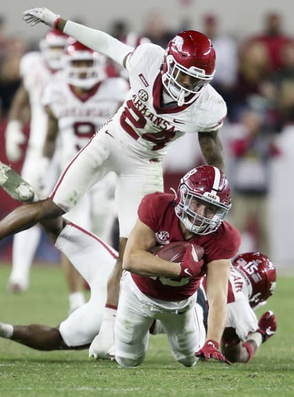 Nov 20, 2021; Tuscaloosa, Alabama, USA;  Arkansas Razorbacks defensive back Simeon Blair (15) and defensive back LaDarrius Bishop (24) tackle Alabama Crimson Tide wide receiver Slade Bolden (18) at Bryant-Denny Stadium. Alabama won 42-35. Mandatory Credit: Gary Cosby Jr.-USA TODAY Sports