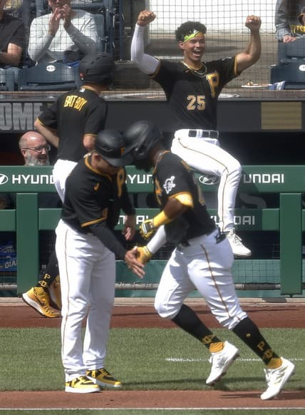Sep 17, 2023; Pittsburgh, Pennsylvania, USA; Pittsburgh Pirates catcher Endy Rodriguez (25) reacts as left fielder Miguel Andujar (right) circles the bases on a solo home run against the New York Yankees during the fourth inning at PNC Park. Mandatory Credit: Charles LeClaire-USA TODAY Sports