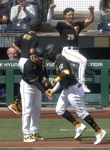 Sep 17, 2023; Pittsburgh, Pennsylvania, USA; Pittsburgh Pirates catcher Endy Rodriguez (25) reacts as left fielder Miguel Andujar (right) circles the bases on a solo home run against the New York Yankees during the fourth inning at PNC Park. Mandatory Credit: Charles LeClaire-USA TODAY Sports