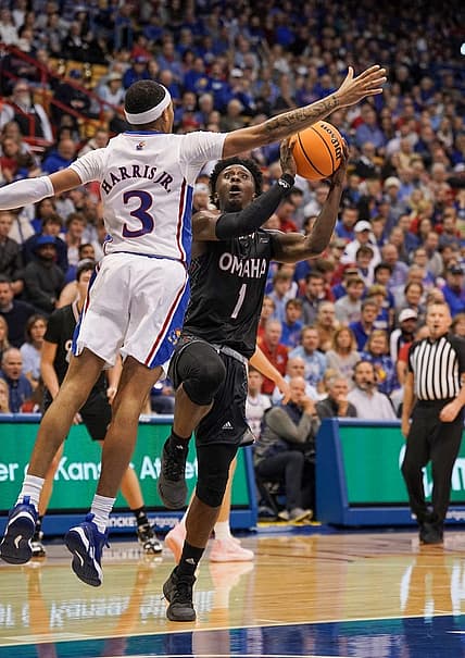 Nov 7, 2022; Lawrence, Kansas, USA; Omaha Mavericks  guard JJ White (1)  shoots as Kansas Jayhawk guard Dajuan Harris Jr. (3) defends during the first half at Allen Fieldhouse. Mandatory Credit: Denny Medley-USA TODAY Sports