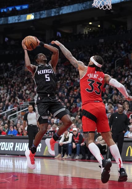 Dec 14, 2022; Toronto, Ontario, CAN; Sacramento Kings guard De'Aaron Fox (5)  drives to the basket as Toronto Raptors guard Gary Trent Jr. (33) tries to defend during the second quarter at Scotiabank Arena. Mandatory Credit: Nick Turchiaro-USA TODAY Sports