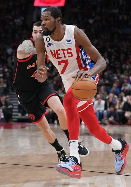Dec 16, 2022; Toronto, Ontario, CAN; Brooklyn Nets forward Kevin Durant (7) controls the ball as Toronto Raptors forward Juancho Hernangomez (41) tries to defend during the second quarter at the Scotiabank Arena. Mandatory Credit: Nick Turchiaro-USA TODAY Sports