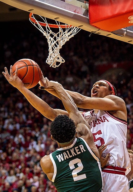 Indiana's Malik Reneau (5) is fouled by Michigan State's Tyson Walker (2) during the first half of the Indiana versus Michigan State men's basketball game at Simon Skjodt Assembly Hall on Sunday, March 10, 2024.