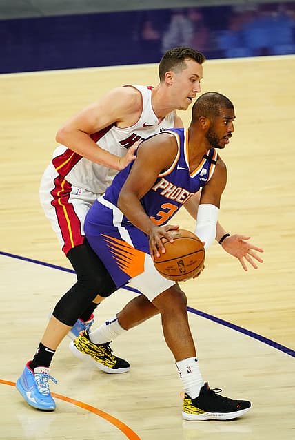 Apr 13, 2021; Phoenix, Arizona, USA; Phoenix Suns guard Chris Paul (3) against Miami Heat guard Duncan Robinson at Phoenix Suns Arena. Mandatory Credit: Mark J. Rebilas-USA TODAY Sports