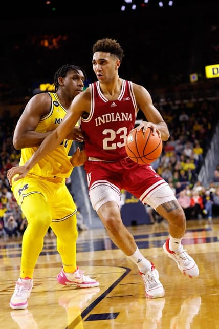 Feb 11, 2023; Ann Arbor, Michigan, USA;  Indiana Hoosiers forward Trayce Jackson-Davis (23) dribbles on Michigan Wolverines forward Tarris Reed Jr. (32) in the second half at Crisler Center. Mandatory Credit: Rick Osentoski-USA TODAY Sports