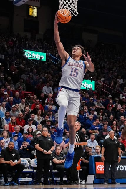 Dec 5, 2023; Lawrence, Kansas, USA; Kansas Jayhawks guard Kevin McCullar Jr. (15) shoots a layup against the UMKC Kangaroos during the first half at Allen Fieldhouse. Mandatory Credit: Denny Medley-USA TODAY Sports