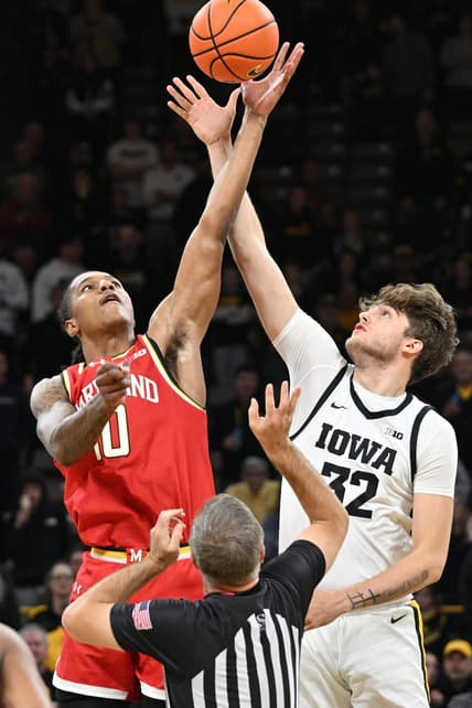Jan 24, 2024; Iowa City, Iowa, USA; Iowa Hawkeyes forward Owen Freeman (32) and Maryland Terrapins forward Julian Reese (10) battle for the opening tipoff during the first half at Carver-Hawkeye Arena. Mandatory Credit: Jeffrey Becker-USA TODAY Sports
