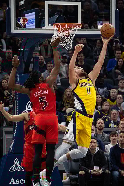 Nov 26, 2021; Indianapolis, Indiana, USA; Indiana Pacers forward Domantas Sabonis (11) shoots the ball while Toronto Raptors forward Precious Achiuwa (5) defends in the first quarter at Gainbridge Fieldhouse. Mandatory Credit: Trevor Ruszkowski-USA TODAY Sports