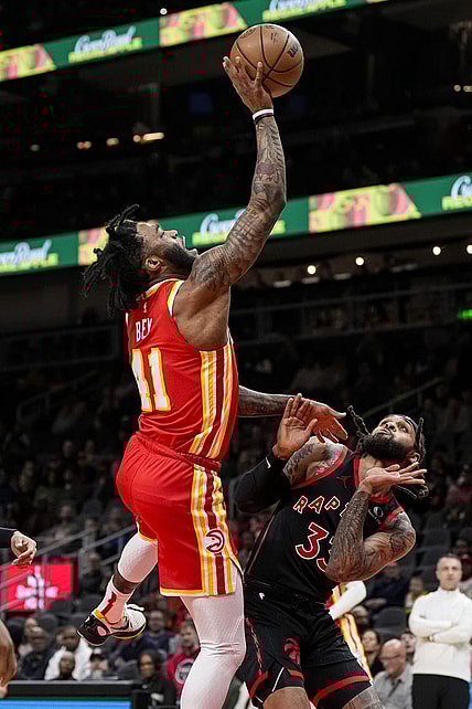 Jan 28, 2024; Atlanta, Georgia, USA; Atlanta Hawks forward Saddiq Bey (41) puts back a rebound over Toronto Raptors guard Gary Trent Jr. (33) during the first half at State Farm Arena. Mandatory Credit: Dale Zanine-USA TODAY Sports
