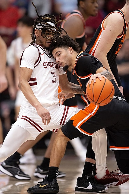 Feb 24, 2024; Stanford, California, USA; Oregon State Beavers guard Jordan Pope (right) collides with Stanford Cardinal guard Kanaan Carlyle (3) during the first half at Maples Pavilion. Mandatory Credit: D. Ross Cameron-USA TODAY Sports