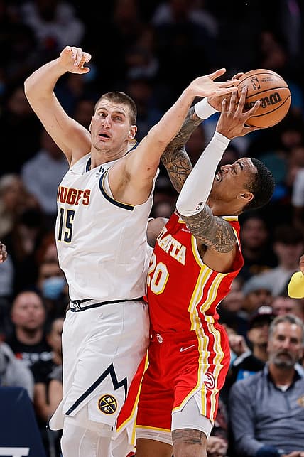 Nov 12, 2021; Denver, Colorado, USA; Denver Nuggets center Nikola Jokic (15) and Atlanta Hawks forward John Collins (20) battle for a rebound in the second quarter at Ball Arena. Mandatory Credit: Isaiah J. Downing-USA TODAY Sports