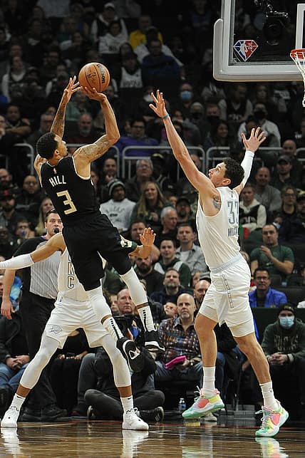 Nov 19, 2021; Milwaukee, Wisconsin, USA;  Milwaukee Bucks guard George Hill (3) puts up a shot against Oklahoma City Thunder center Mike Muscala (33) in the first half at Fiserv Forum. Mandatory Credit: Michael McLoone-USA TODAY Sports