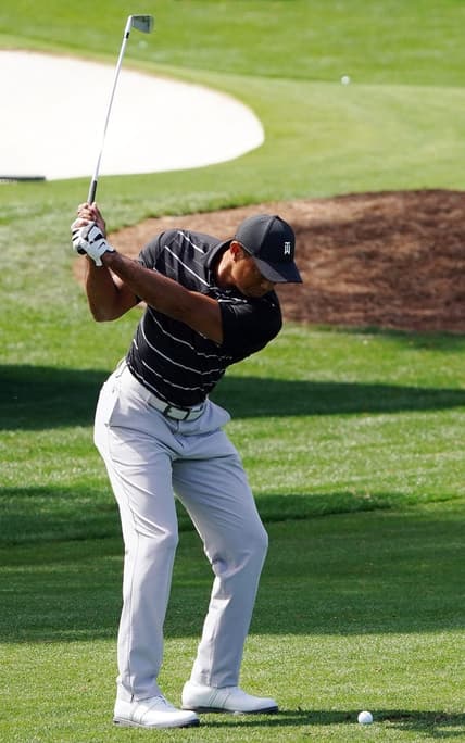 Apr 2, 2023; Augusta, Georgia, USA; Tiger Woods warms up on the practice range in preparation for the Masters Tournament at Augusta National Golf Club. Mandatory Credit: Katie Goodale-USA TODAY Sports