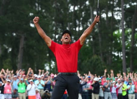 Tiger Woods celebrates after making a putt on the 18th green to win The Masters golf tournament at Augusta National Golf Club on