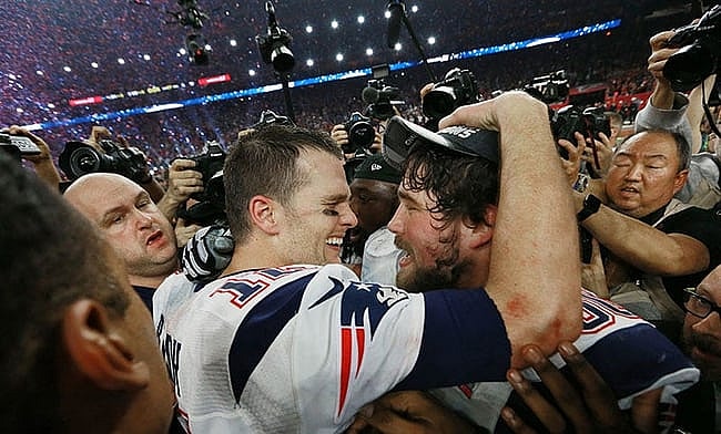 In 2017 Tom Brady celebrates with center David Andrews after the game.