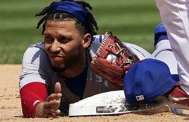 May 29, 2022; Chicago, Illinois, USA; Chicago Cubs infielder Andrelton Simmons (19) forces out Chicago White Sox shortstop Danny Mendick (20) at second base during the sixth inning at Guaranteed Rate Field. Mandatory Credit: David Banks-USA TODAY Sports