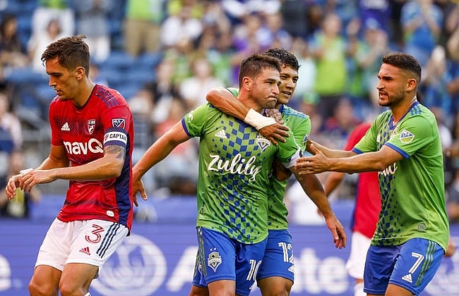 Aug 2, 2022; Seattle, Washington, USA; Seattle Sounders FC midfielder Nicolas Lodeiro (10) celebrates with forward Fredy Montero (12) and midfielder Cristian Roldan (7) after scoring a goal on a penalty kick against FC Dallas during the first half at Lumen Field. FC Dallas defender Jos   Antonio Martinez (3) retrieves the ball at left. Mandatory Credit: Joe Nicholson-USA TODAY Sports