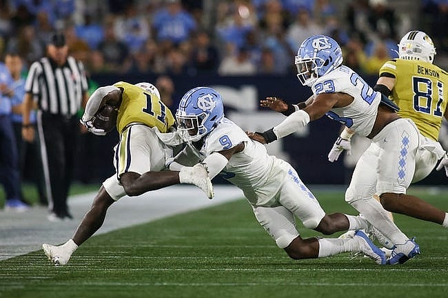 Oct 28, 2023; Atlanta, Georgia, USA; North Carolina Tar Heels defensive back Armani Chatman (9) tackles Georgia Tech Yellow Jackets running back Jamal Haynes (11) in the first half at Bobby Dodd Stadium at Hyundai Field. Mandatory Credit: Brett Davis-USA TODAY Sports
