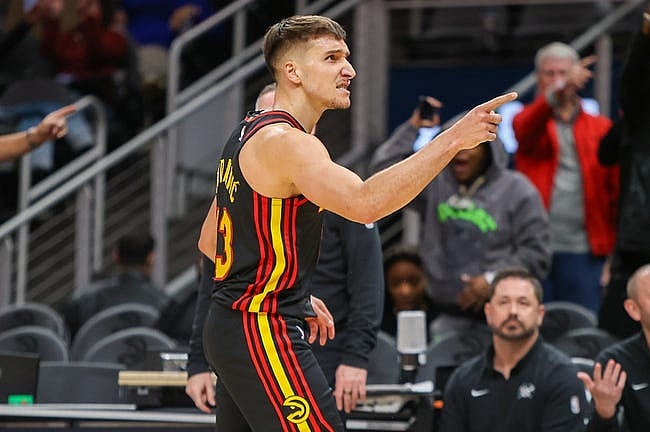 Dec 11, 2023; Atlanta, Georgia, USA; Atlanta Hawks guard Bogdan Bogdanovic (13) reacts after a basket against the Denver Nuggets in the second half at State Farm Arena. Mandatory Credit: Brett Davis-USA TODAY Sports