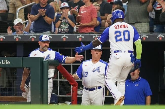 Jul 28, 2023; Atlanta, Georgia, USA; Atlanta Braves designated hitter Marcell Ozuna (20) celebrates with bench coach Walt Weiss (4) and manager Brian Snitker (43) after scoring against the Milwaukee Brewers in the second inning at Truist Park. Mandatory Credit: Brett Davis-USA TODAY Sports