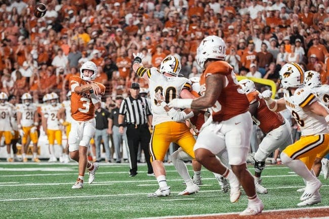Texas Longhorns quarterback Quinn Ewers (3) throws a touchdown pass to Texas Longhorns defensive lineman Byron Murphy II (90) during the Texas Longhorns' game against the Wyoming Cowboys, Saturday, Sept. 16 at Darrell K Royal   Texas Memorial Stadium in Austin.