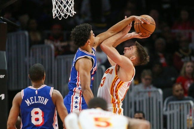 Jan 10, 2024; Atlanta, Georgia, USA; Philadelphia 76ers guard Jaden Springer (11) fouls Atlanta Hawks guard Bogdan Bogdanovic (13) on a block attempt in the second quarter at State Farm Arena. Mandatory Credit: Brett Davis-USA TODAY Sports
