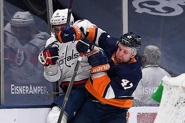 Apr 6, 2021; Uniondale, New York, USA; New York Islanders right wing Leo Komarov (47) checks Washington Capitals left wing Alex Ovechkin (8) into the boards during the second period between the New York Islanders and the Washington Capitals at Nassau Veterans Memorial Coliseum. Mandatory Credit: Dennis Schneidler-USA TODAY Sports