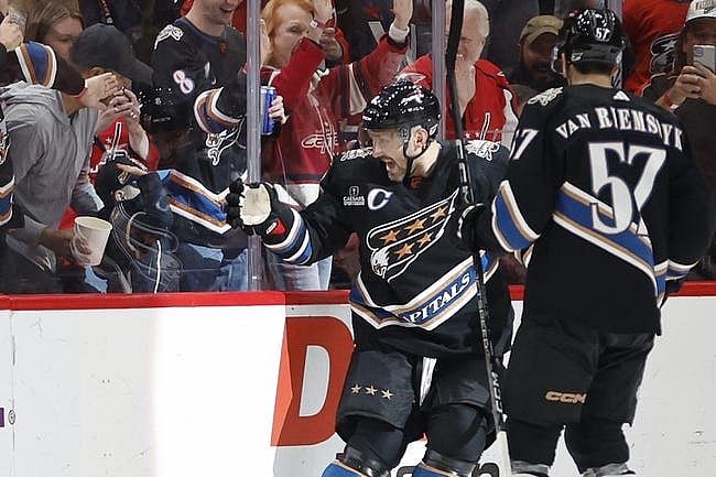 Jan 3, 2023; Washington, District of Columbia, USA; Washington Capitals left wing Alex Ovechkin (8) gestures towards a young fan after scoring a goal against the Buffalo Sabres in the third period at Capital One Arena. Mandatory Credit: Geoff Burke-USA TODAY Sports