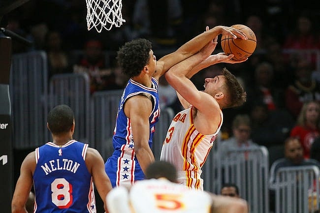 Jan 10, 2024; Atlanta, Georgia, USA; Philadelphia 76ers guard Jaden Springer (11) fouls Atlanta Hawks guard Bogdan Bogdanovic (13) on a block attempt in the second quarter at State Farm Arena. Mandatory Credit: Brett Davis-USA TODAY Sports