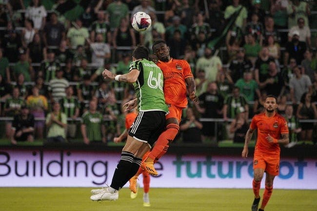 Jun 24, 2023; Austin, Texas, USA; Austin FC defender Aleksandar Radovanovic (66) and Houston Dynamo forward Ibrahim Aliyu (18) jump for the ball during the first half at Q2 Stadium. Mandatory Credit: Dustin Safranek-USA TODAY Sports