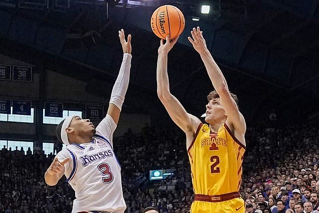 Jan 14, 2023; Lawrence, Kansas, USA; Iowa State Cyclones guard Caleb Grill (2) shoots a three point shot against Kansas Jayhawks guard Dajuan Harris Jr. (3) during the first half at Allen Fieldhouse. Mandatory Credit: Denny Medley-USA TODAY Sports