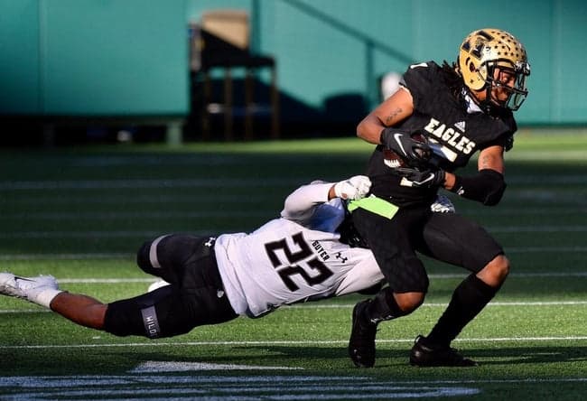 Abilene High receiver Frederick Johnson (7) tries to break a tackle of Denton Guyer's Peyton Bowen (22) during the first half of Saturday's Region I-6A Division II semifinal at Globe Life Park in Arlington.

Ahs Fb Dguyer Halftime