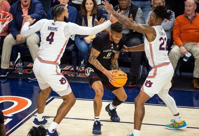 Texas A&M Aggies guard Dexter Dennis (0) looks to pass out of a trap as Auburn Tigers take on Texas A&M Aggies at Neville Arena in Auburn, Ala., on Wednesday, Jan. 25, 2023. Texas A&M Aggies defeated Auburn Tigers 79-63.