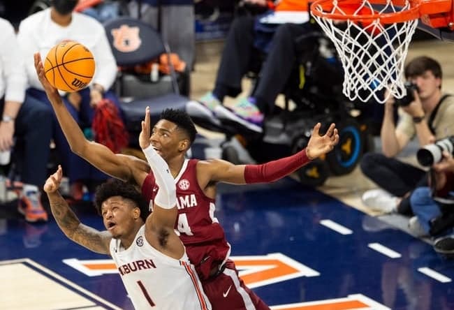 Auburn Tigers guard Wendell Green Jr. (1) and Alabama Crimson Tide player Brandon Miller (24) go after a rebound as Auburn Tigers take on Alabama Crimson Tide at Neville Arena in Auburn, Ala., on Saturday, Feb. 11, 2023. Alabama Crimson Tide defeated Auburn Tigers 77-69.