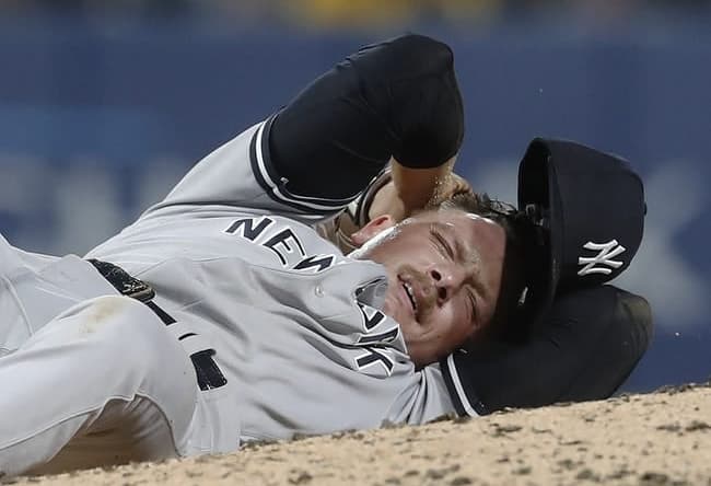 Sep 15, 2023; Pittsburgh, Pennsylvania, USA;  New York Yankees relief pitcher Anthony Misiewicz (54) reacts after being hit in the head by a line drive off the bat of Pittsburgh Pirates second baseman Ji Hwan Bae (not pictured) during the sixth inning at PNC Park. Misiewicz would leave the game.Mandatory Credit: Charles LeClaire-USA TODAY Sports