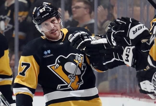 Jan 2, 2024; Pittsburgh, Pennsylvania, USA; Pittsburgh Penguins center Sidney Crosby (87) celebrates with the Pens bench after scoring a power play goal against the Washington Capitals during the second period at PPG Paints Arena. Mandatory Credit: Charles LeClaire-USA TODAY Sports