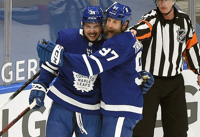 Feb 18, 2021; Toronto, Ontario, CAN;  Toronto Maple Leafs forward Auston Matthews (34) is greeted by forward Joe Thornton (97) after scoring against Ottawa Senators in the first period at Scotiabank Arena. Mandatory Credit: Dan Hamilton-USA TODAY Sports