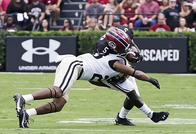 Oct 16, 2021; Columbia, South Carolina, USA; Vanderbilt Commodores cornerback Jaylen Mahoney (23) tackles South Carolina Gamecocks wide receiver Dakereon Joyner (5) at Williams-Brice Stadium. Mandatory Credit: David Yeazell-USA TODAY Sports